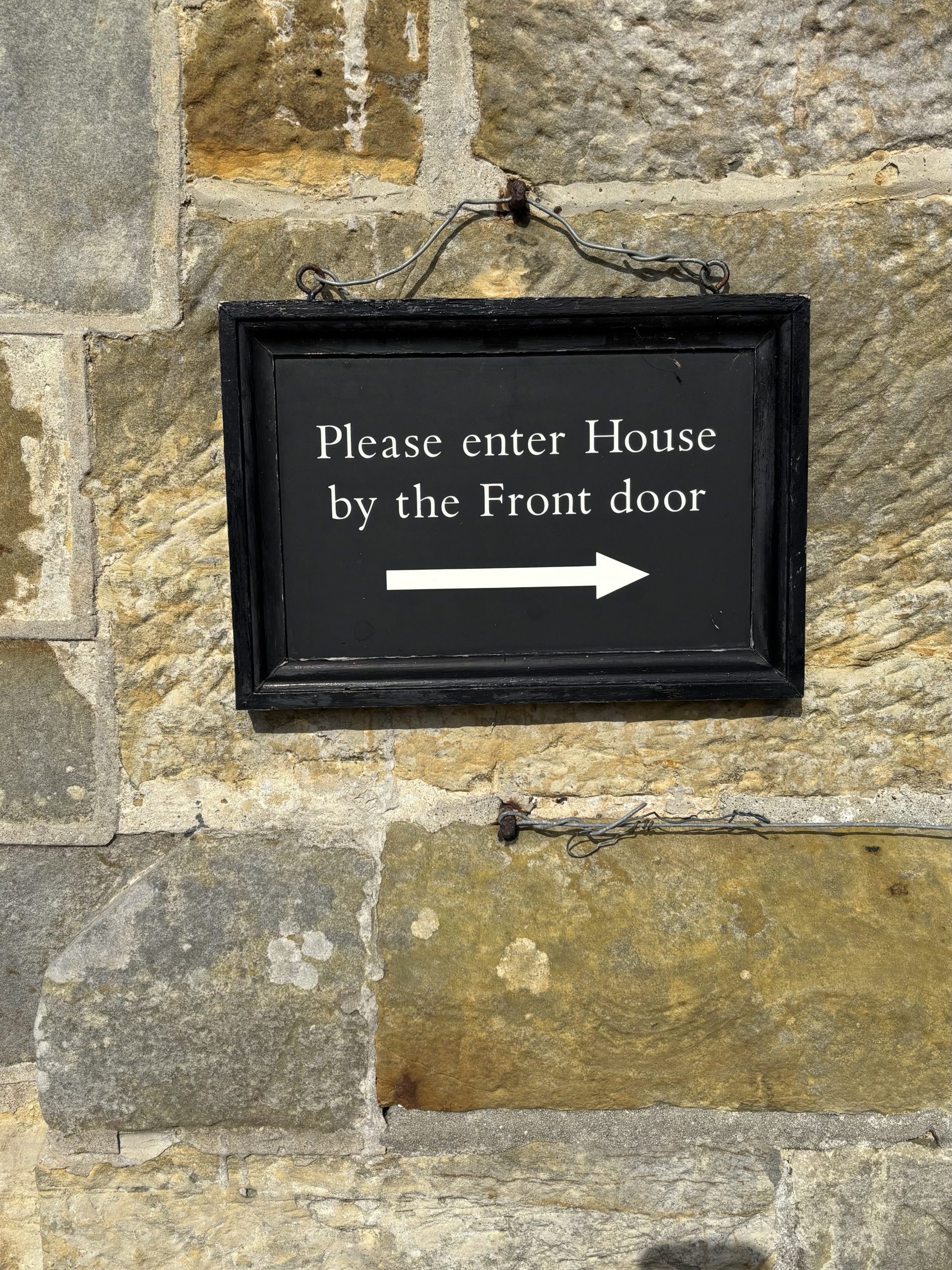 Our Channels - Sign pointing to front door
